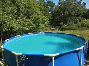 a large pool of blue water in a field at Еко-садиба БАКОТА in Kolodiyevka