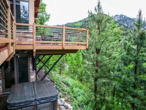 a deck on a house in the woods at Honeycomb View in Brighton