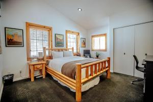 a bedroom with a bed and a desk and two windows at Great Western in Brighton