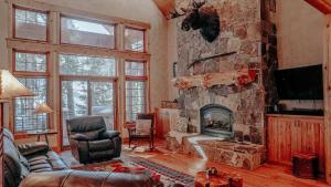 a living room with a large stone fireplace at Rivamonte in Brighton