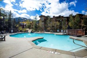 a large swimming pool in a resort at First Tracks Townhome in Solitude