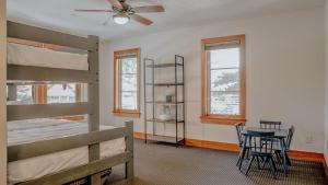 a bedroom with two bunk beds and a table and chairs at Basecamp in Solitude