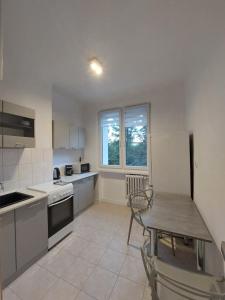 a kitchen with a table and a table and a table and a table at Apartament Aleja 29 Listopada in Kraków +30 photos