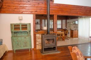 a living room with a wood stove in it at Casa La Selva in Sierra de los Padres