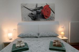 a bedroom with a bed with two slippers on it at Open Space in Bassano del Grappa