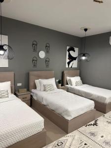 Postel nebo postele na pokoji v ubytování Sunset Apartments