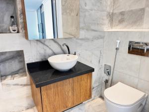 a bathroom with a sink and a toilet at Playablanca Luxury Beach Apartment First Floor in Tanger in Tangier +17 photos