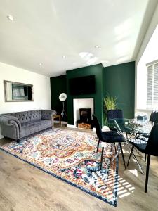 a living room with a couch and a fireplace at Sophisticated Home with Beautiful & Large Garden in Cardiff