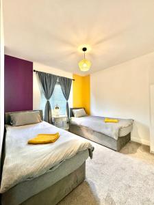 a bedroom with two beds and a window at Sophisticated Home with Beautiful & Large Garden in Cardiff