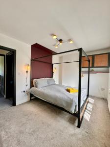 a bedroom with a bed with a canopy at Sophisticated Home with Beautiful & Large Garden in Cardiff