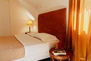 a bedroom with a bed and a table with a book at Domaine Foray in Villecien