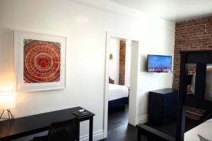 a bedroom with a bed and a desk in a room at American Hotel in Los Angeles
