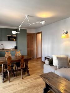 a living room with a table and a couch at Au Coeur de Courmayeur in Courmayeur