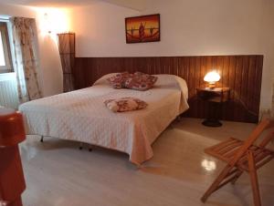 a bedroom with a bed and a chair at Amuri di casa in Calascibetta +10 photos