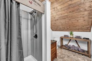 a bathroom with a shower and a wooden wall at Rustic Barn Retreat in Knoxville +29 photos