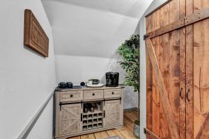 a room with a wooden door and a wooden cabinet at Rustic Barn Retreat in Knoxville