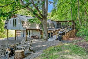 a house with a staircase and a tree at Rustic Barn Retreat in Knoxville