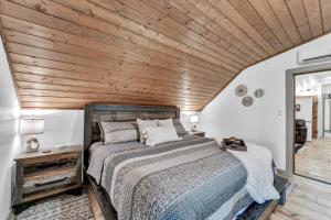 a bedroom with a bed and a wooden ceiling at Rustic Barn Retreat in Knoxville