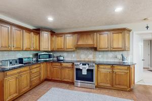 a large kitchen with wooden cabinets and appliances at Borrowed Heaven in Mineral