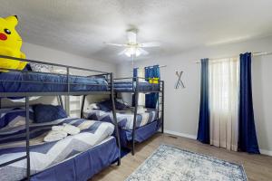 a bedroom with two bunk beds and a ceiling fan at Borrowed Heaven in Mineral