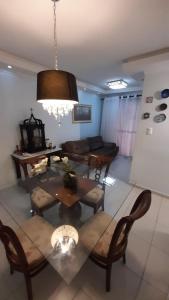 a living room with a table and chairs at Bela Providência in Aracaju