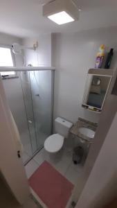 a small bathroom with a toilet and a shower at Bela Providência in Aracaju