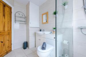 a bathroom with a toilet and a sink at NEW! 3-Bed Spacious Home in Manchester by 53 Degrees Property, Ideal for Groups, FREE Parking! in Manchester +35 photos