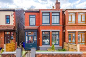 a red brick house with a blue door at NEW! 3-Bed Spacious Home in Manchester by 53 Degrees Property, Ideal for Groups, FREE Parking! in Manchester