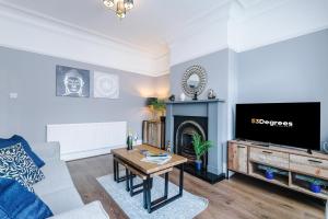 a living room with a fireplace and a tv at NEW! 3-Bed Spacious Home in Manchester by 53 Degrees Property, Ideal for Groups, FREE Parking! in Manchester