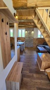 a large room with wooden floors and wooden stairs at Apartmani Cvijeta in Žabljak