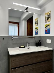 a bathroom with a sink and a mirror at Au Coeur de Courmayeur in Courmayeur