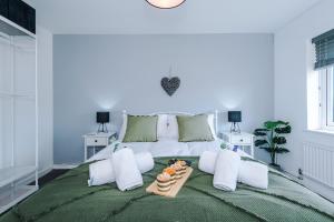 a white bed with a tray of food on it at NEW! 3-Bed Stunning Bungalow in Wrexham by 53 Degrees Property, Ideal for Groups, FREE Parking! in Wrexham +32 photos