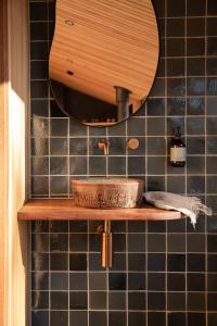 a bathroom with a sink and a mirror at Hunter Huon Valley Cabin Two in Glen Huon