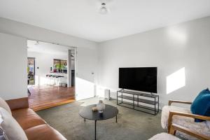 a living room with a couch and a flat screen tv at Stonehaven in Wanaka