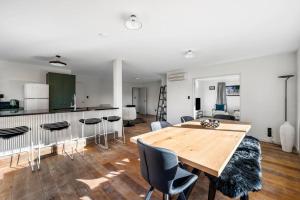 a kitchen and dining room with a wooden table and chairs at Stonehaven in Wanaka