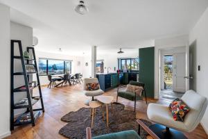 a large living room with chairs and a table at Stonehaven in Wanaka
