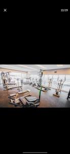 a gym with a bunch of treadmills and machines at Flat Hotel Saint Moritz ap 2008 in Brasilia