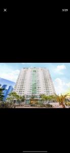 a large white building with trees in front of it at Flat Hotel Saint Moritz ap 2008 in Brasilia