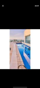 a picture of a swimming pool in front of a building at Flat Hotel Saint Moritz ap 2008 in Brasilia