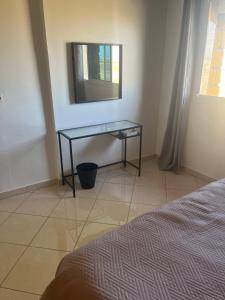 a bedroom with a table and a mirror on the wall at Beachhouse Asilah in Asilah