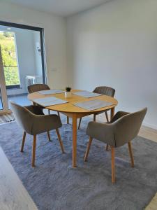 a wooden table and chairs in a room at Loreto House in Bragança +8 photos