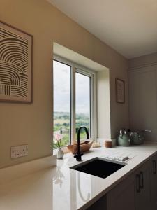 a kitchen with a sink and a window at Haworth Holiday Home in Haworth +11 photos