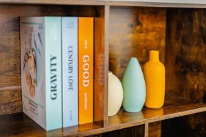a shelf with three vases and a book at Groovy Getaway with Fenced Yard in Augusta