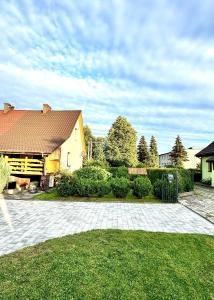ein Haus mit einer gemauerten Auffahrt vor einem Garten in der Unterkunft Domek u podnóża Skrzycznego in Lipowa