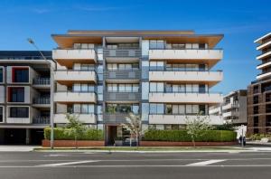 an apartment building with balconies on a city street at Brand New 2br2ba Caulfield Parkbalcony Poolgym in Melbourne