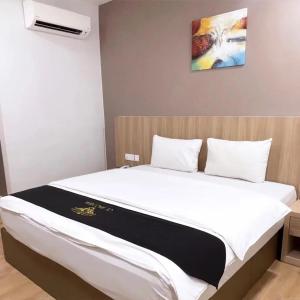 a large bed in a room with at Maple Boutique Hotel in Melaka