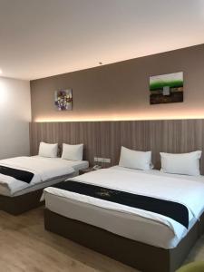 Postel nebo postele na pokoji v ubytování Maple Boutique Hotel
