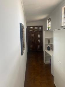 a hallway with a door and a wooden floor at Apartamente Arcul de Triumf in Bucharest +10 photos