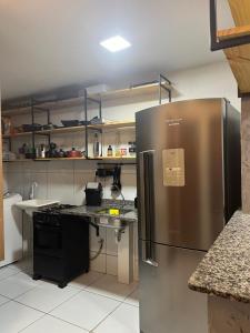 a kitchen with a large stainless steel refrigerator at Impera House Bom para Empresas in Imperatriz