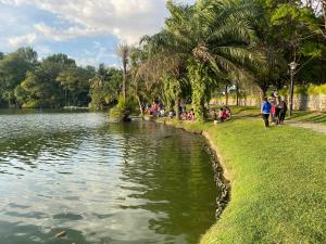 people walking around a lake in a park at Tamu House Botani in Ipoh